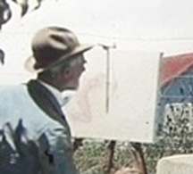 close-up of Joseph
              Henry Sharp painting an Indian