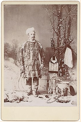 Man with a collection of
        Tlingit objects. Cabinet card with backmark of Melander,
        Chicago. I don't know who he is.